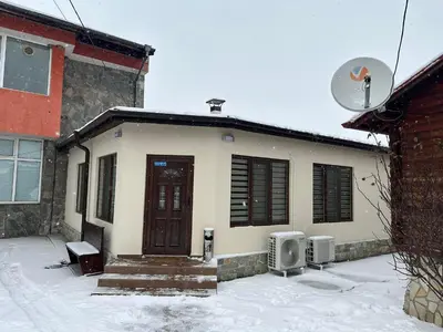 a small house with snow on the ground in front of it at Къща за гости Елит (Guest House Elite) in Sapareva Banya
