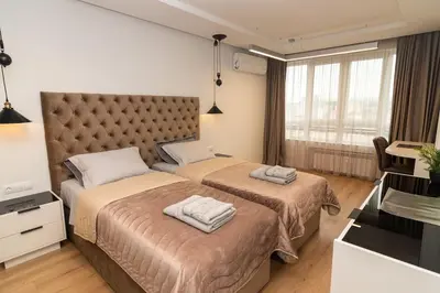 a hotel room with two beds and a television at Gran Capital Top Central Apartment in Sofia