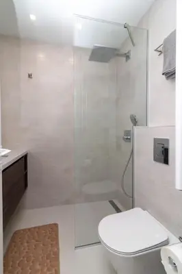a bathroom with a toilet and a glass shower at Gran Capital Top Central Apartment in Sofia