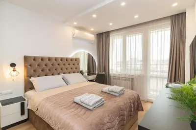 a bedroom with a large bed with two towels on it at Gran Capital Top Central Apartment in Sofia
