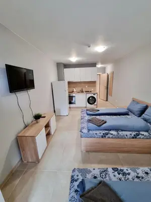 a living room with two beds and a kitchen at Top location apartment in Sofia
