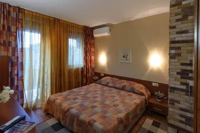 a hotel room with a bed and a window at Cosy room in the center of Bansko in Bansko