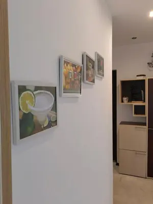 a group of pictures on a wall in a room at Alexander Apartments Kyustendil in Kyustendil