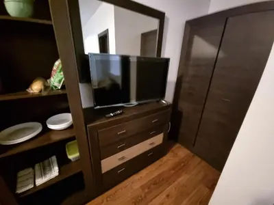 a television sitting on a dresser with a mirror at Bansko Royal Towers apartment 200m from skilift in Bansko