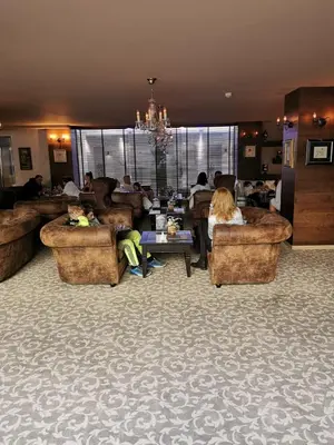 a group of people sitting in a living room at Suite Roma 1 at Royal Spa in Velingrad