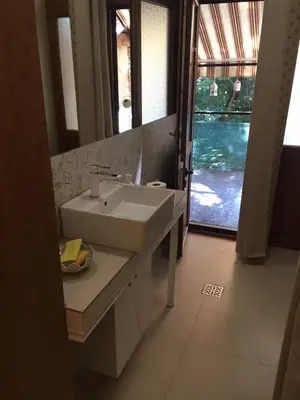 a bathroom with a sink and a mirror and a window at My place - 24h Self Check-in in Sofia