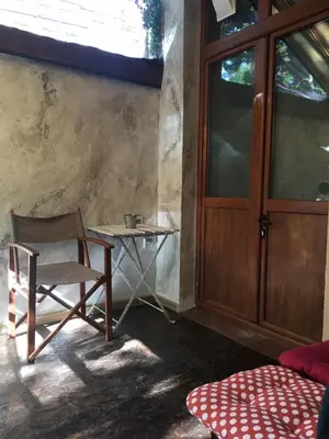 a chair and a table in a room with a door at My place - 24h Self Check-in in Sofia