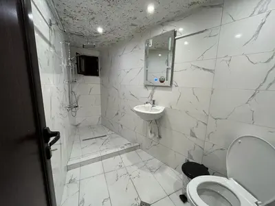 a white bathroom with a toilet and a sink at Apartments Dream in Sarnitsa