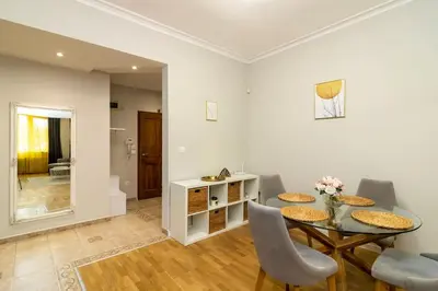 a dining room with a table and chairs at Spacious Aristocratic Apt. with a Colourful View in Sofia