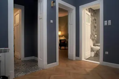 a hallway with a bathroom with a toilet and a mirror at *CITADEL* 2BR - city center in Sofia