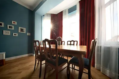 a dining room with a wooden table and chairs at *CITADEL* 2BR - city center in Sofia