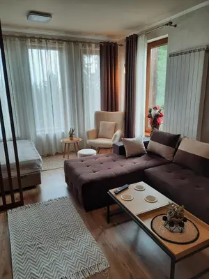 a living room with a couch and a table at Apartment Svetoslava in Pamporovo