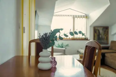a white vase sitting on a table in a living room at Large 2-bedroom apt near ski road, 5 min to Gondola & Bar Street in Bansko