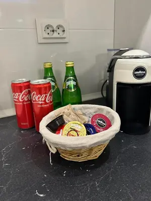 two cocacola soda bottles and a basket on a counter at Elegant Stay in the Heart of Plovdiv Old Town in Plovdiv