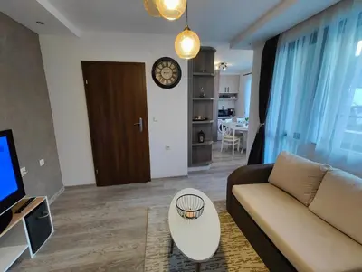 a living room with a couch and a table at Апартамент РАЯ in Chepelare