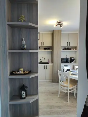 a kitchen and a dining room with a table at Апартамент РАЯ in Chepelare