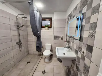 a bathroom with a toilet and a sink at Апартамент за гости Криси гр. Девин in Devin