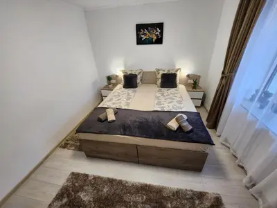 a bedroom with a large bed with two pillows at Апартамент за гости Криси гр. Девин in Devin
