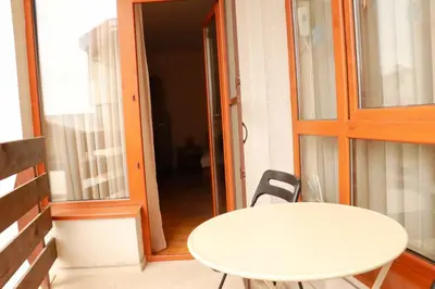 a white table and a chair on a balcony at Pirin Palace in Bansko