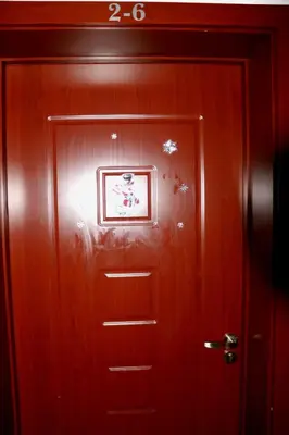 a wooden door with a picture on top of it at Pirin Palace in Bansko