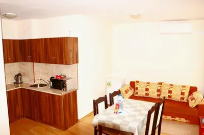 a small kitchen with a table and a couch at Pirin Palace in Bansko