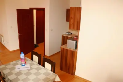 a dining room with a table and a microwave at Pirin Palace in Bansko