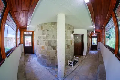 a room with a stone fireplace in a house at Pamporovo Cottage Savov in Pamporovo