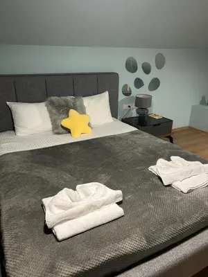 a bedroom with a bed with towels on it at Cozy Apartment B35 in Grand Resort Pamporovo in Pamporovo