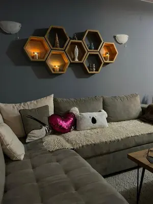 a living room with a couch with a heart on the wall at Cozy Apartment B35 in Grand Resort Pamporovo in Pamporovo