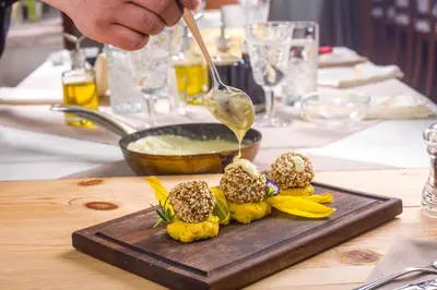 a person is eating food on a cutting board at Парк-Хотел Клементина in Trud