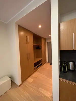 a kitchen with wooden cabinets and a counter top at Lodge Euphoria Apartment in Borovets