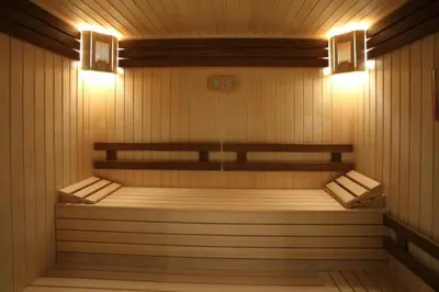 a sauna with two benches and two lights at Lodge Euphoria Apartment in Borovets