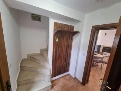 a staircase with a wooden door in a room at Private Chalets Bansko in Bansko