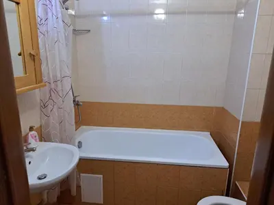 a bathroom with a bath tub and a sink at Private Chalets Bansko in Bansko