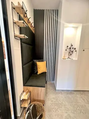 a hallway with a black leather bench in a room at Boutique lux design apartment @Bansko Royal Towers in Bansko