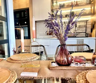 a table with a vase with flowers in it at Boutique lux design apartment @Bansko Royal Towers in Bansko