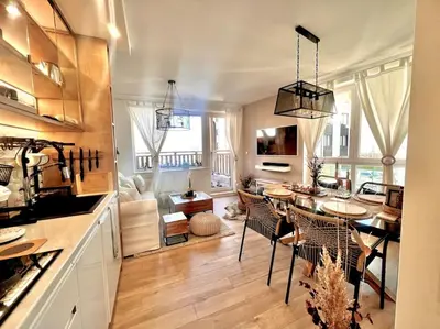 a kitchen and living room with a table and chairs at Boutique lux design apartment @Bansko Royal Towers in Bansko
