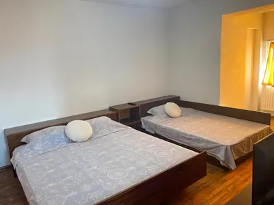 a room with two beds and a window at Alpin Guest House in Sapareva Banya