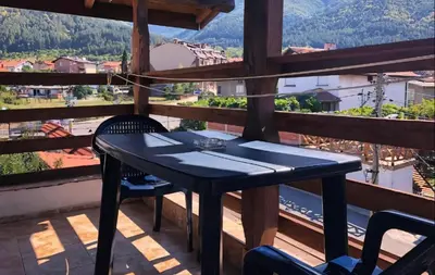 a black table and chairs on a balcony with a view at Alpin Guest House in Sapareva Banya