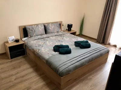 a bedroom with a bed with two pillows on it at Luxury apartment 1 Free Underground Secure Parking in Pazardzhik