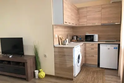 a kitchen with a washer and dryer in a room at Luxury apartment 2 Free Underground Secure Parking in Pazardzhik