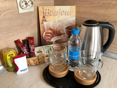 a tray with a coffee pot and glasses on a counter at Luxury apartment 2 Free Underground Secure Parking in Pazardzhik