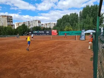 a group of people playing tennis on a tennis court at Luxury apartment 2 Free Underground Secure Parking in Pazardzhik