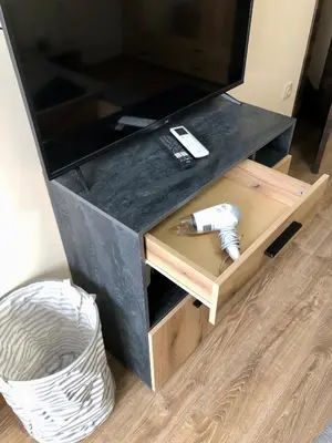 a wooden tv stand with a television on top at Luxury apartment 2 Free Underground Secure Parking in Pazardzhik