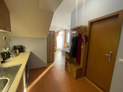 a kitchen with a door open to a kitchen with a sink at Your Place Borovets in Borovets