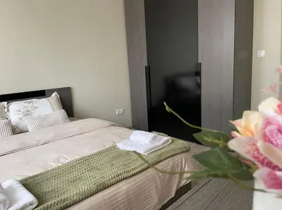 a bedroom with a bed with a green towel on it at Mila's 1 Bedroom Apartment in Sofia