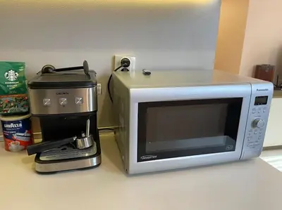 a microwave sitting on a counter next to a coffee maker at Mila's 1 Bedroom Apartment in Sofia