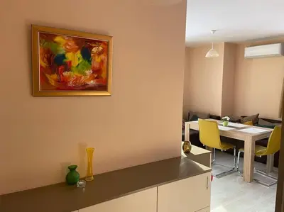 a kitchen and dining room with a painting on the wall at Mila's 1 Bedroom Apartment in Sofia