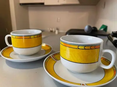 two cups and saucers sitting on a kitchen counter at Mila's 1 Bedroom Apartment in Sofia