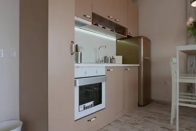 a kitchen with a sink and a stove at Charmful new flat with Hill view in Plovdiv